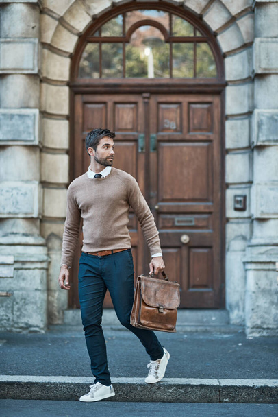 Hes got business to attend to. Full length shot of a handsome businessman with a satchel about town. - Fotografie, Obrázek