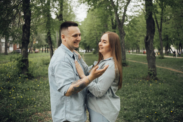 loving couple walking in ukrainian park and city - Foto, Imagen