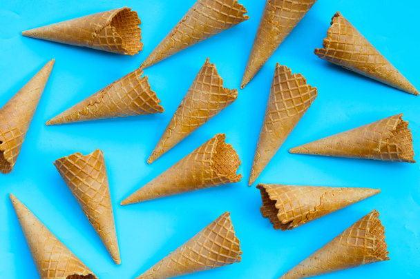 Empty ice cream cone on blue background. - Photo, Image