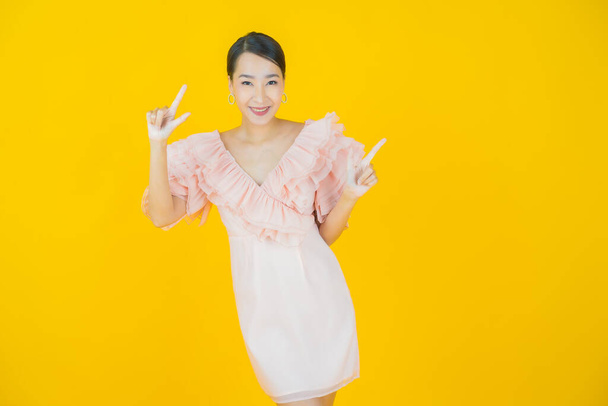 Portrait beautiful young asian woman smile with action on color background - Foto, imagen