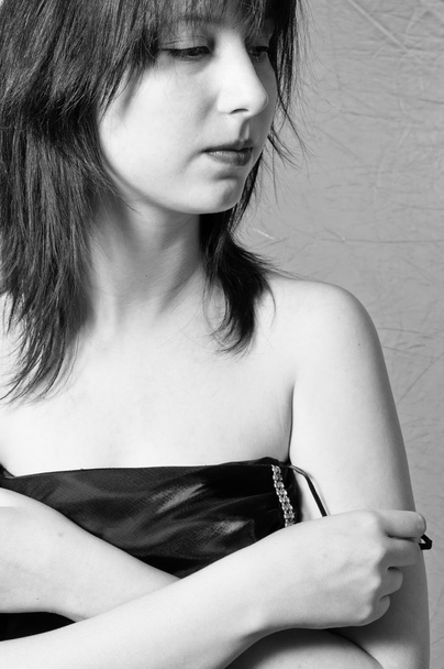 A beautiful young girl undressing in black and white - Fotografie, Obrázek