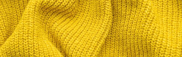 Texture of yellow knitted fabric as background. Banner for design - Foto, Bild