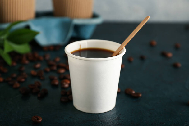 Takeaway paper cup of coffee on table - Foto, Bild