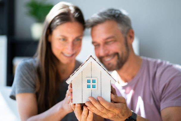 Happy Family Buying New House. Couple With Real Estate In Hands - Photo, Image