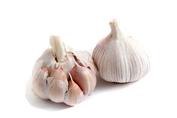 Isolated garlic. Fresh peeled garlic cloves, bulb with garlic slices isolated on white background. clipping path. - Photo, Image