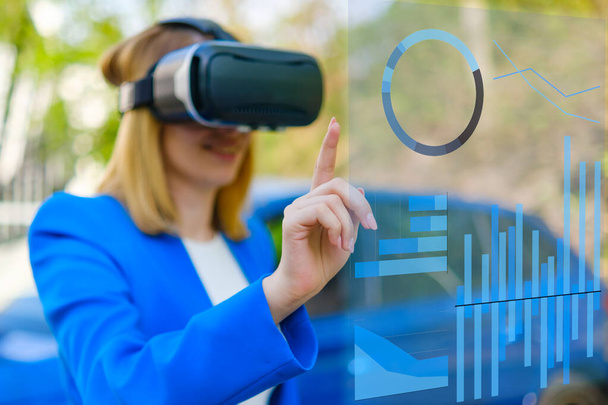 Attractive woman enjoying virtual reality glasses and managing the graphics in augmented reality - Foto, Bild