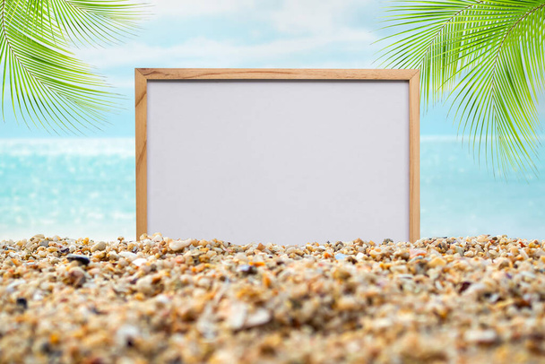 Mockup on sea with leaves palm at coast. blank board on sand beach and blue oceand seaside and blue sky. white board free space wite coconut for Tropical tourism relax vacation travel summer holidays. - Fotografie, Obrázek