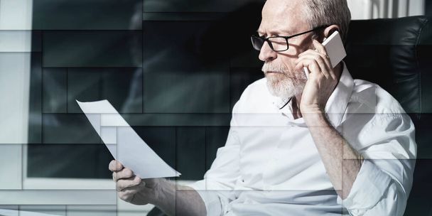 Bearded senior businessman talking on mobile phone in office, hard light, geometric pattern - Фото, изображение