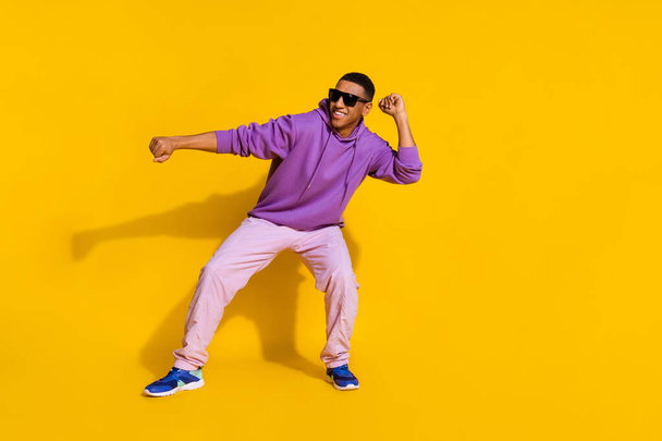 Full length body size view of attractive cheerful cool guy having fun dancing clubbing isolated over bright yellow color background - Foto, Imagem