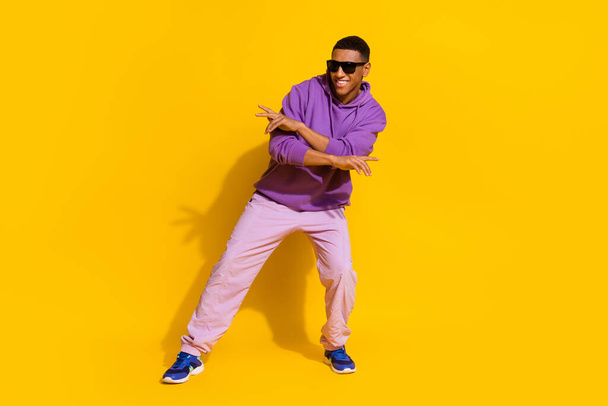 Full length body size view of attractive cheerful guy dancing moving rest street isolated over bright yellow color background - 写真・画像