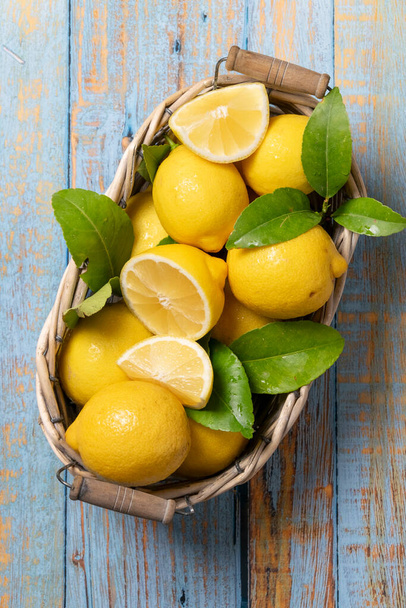 Raw fresh lemons on light wooden background. Harvest, agricultural concept, healthy organic ingredients - Foto, Imagem