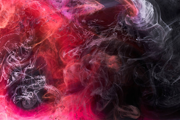 Black and red ink background, colorful fog, abstract swirling ocean, acrylic paint pigment underwater, white smoke - Photo, image