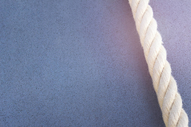 Large rope for climbing on blue background. Image with copy blank space. - Fotoğraf, Görsel