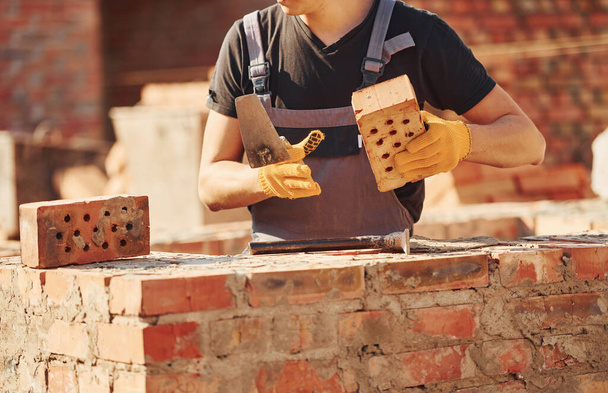 Construction worker in uniform and safety equipment have job on building. - Fotografie, Obrázek