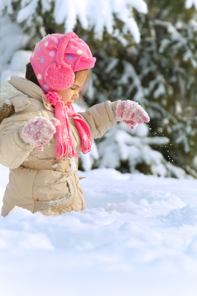 klein kind spelen in sneeuw - Foto, afbeelding