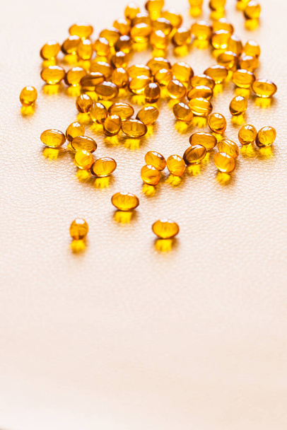 Vitamin D3 capsules. Medicine vitamins and dietary supplements. Selective focus. Close up of oil filled capsules suitable for: fish oil, omega 3, omega 6, omega 9, vitamin A, vitamin D, vitamin D3, vitamin E - Zdjęcie, obraz