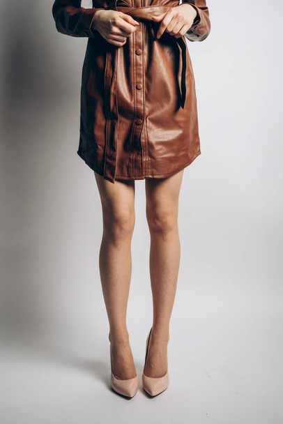 young woman wearing brown leather and nude stilettos  - Fotografie, Obrázek