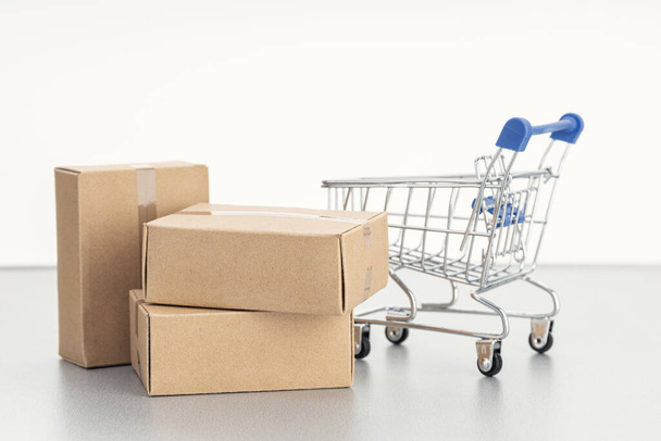 Sale, discount, shopping and delivery concept. Pile of blank Cardboard boxes and shopping cart on white background. Template Mock up. Copy space - Photo, Image