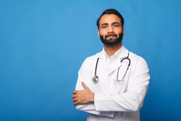Serious Indian male doctor pediatric, physical, therapist wearing white medical gown with stethoscope - Φωτογραφία, εικόνα