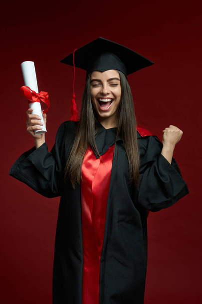 Pretty girl smiling, crying, holding diploma, showing hurray. - Φωτογραφία, εικόνα