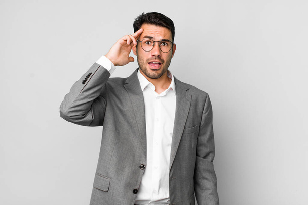 young adult hispanic man looking happy, astonished and surprised. business concept - Photo, Image