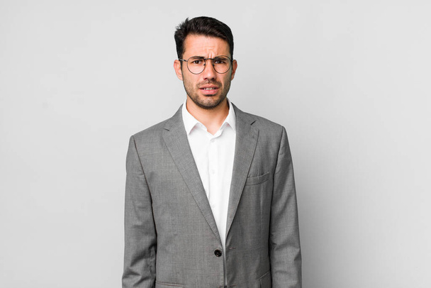 young adult hispanic man feeling puzzled and confused. business concept - Foto, Imagem