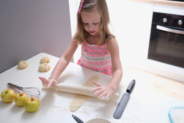 Child girl with rolling pin for baking cookies for dough - Foto, Bild