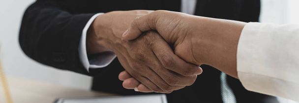 Lawyers or counselors join hands with clients to congratulate the end of the case by the company, Negotiation or settlement of lawsuits concept. - Фото, зображення