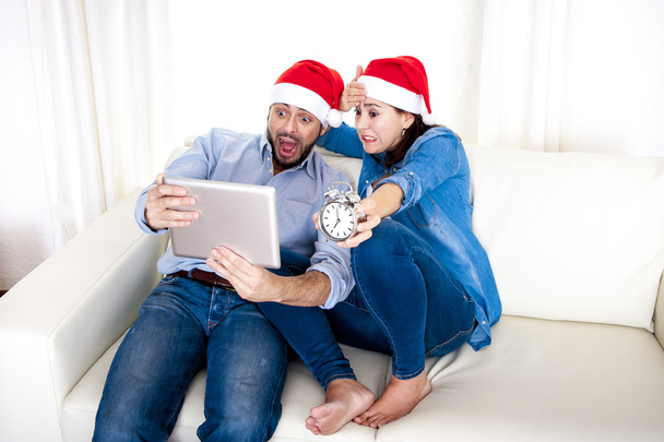 Young attractive Hispanic couple online Christmas late shopping with digital tablet - Photo, Image