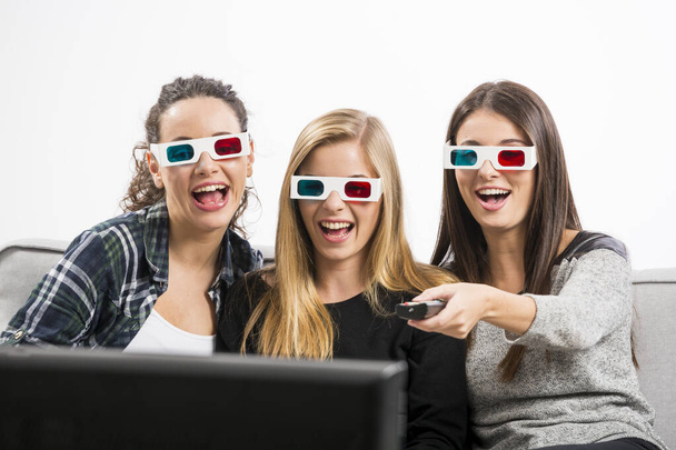 Girls watching 3D movies with popcorn - Photo, image