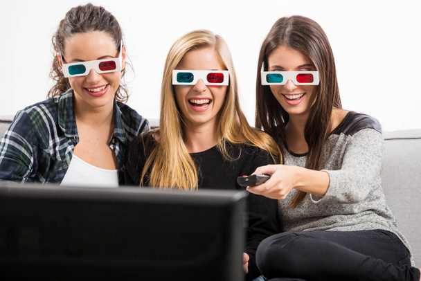 Girls watching 3D movies with popcorn - Photo, image
