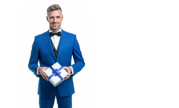 cheerful man in blue suit with gift box isolated on white. valentines day - Foto, imagen