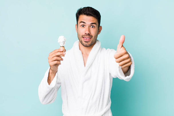 young adult hispanic man feeling proud,smiling positively with thumbs up. shaving concept - Φωτογραφία, εικόνα