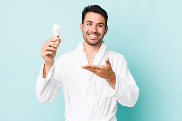 young adult hispanic man smiling cheerfully, feeling happy and showing a concept. shaving concept - Φωτογραφία, εικόνα