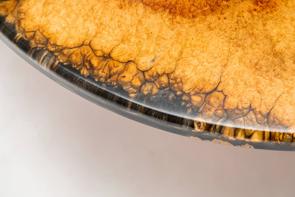Closeup of epoxy resin round table edge on white background - Photo, Image