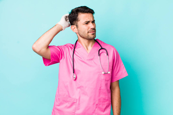 young adult hispanic man smiling happily and daydreaming or doubting. veterinarian concept - Photo, image