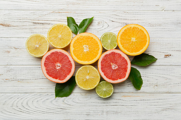 Fruit background. Colorful fresh fruits on colored table. Orange, lemon, grapefruit Space for text healthy concept. Flat lay, top view, copy space. - Foto, Bild