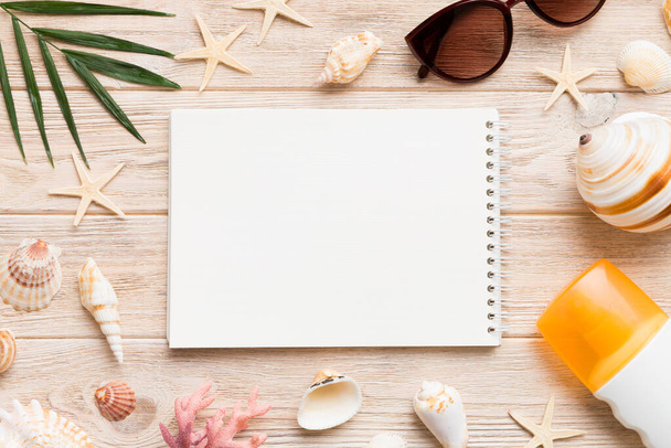 Blank writing book with summer beach accessories on background, copy space. Flat lay with copy space. - Photo, image