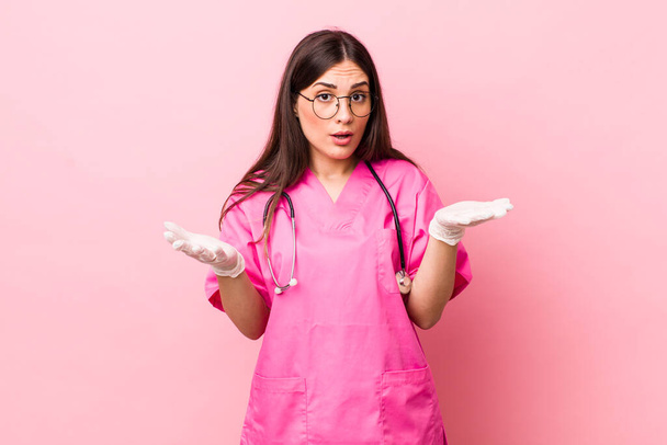 young pretty woman feeling extremely shocked and surprised. veterinarian concept - Foto, Imagen