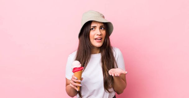 young pretty woman looking desperate, frustrated and stressed. summer and ice cream concept - Fotoğraf, Görsel