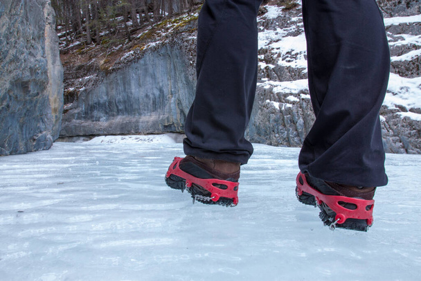 Female hiker on a icewalk on frozen Grotto Creek near Canmore, Alberta - Photo, image