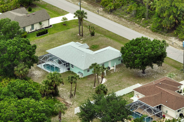 Luchtfoto van voorstedelijk landschap met prive-woningen tussen groene palmbomen in Florida rustige woonwijk - Foto, afbeelding