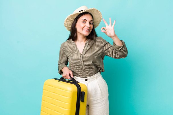 young pretty woman feeling happy, showing approval with okay gesture. travel concept - Foto, immagini