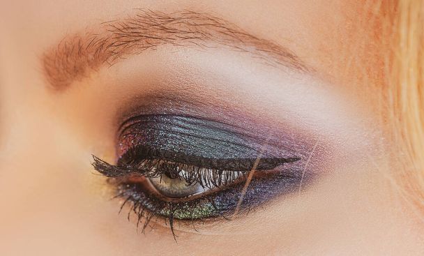 Beauty salon. Female eye with bright makeup. Visage cosmetics. Smokey eyes. - Fotoğraf, Görsel