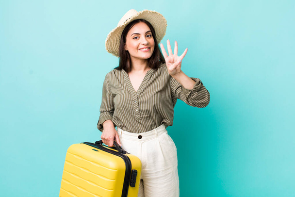 young pretty woman smiling and looking friendly, showing number four. travel concept - Foto, Bild
