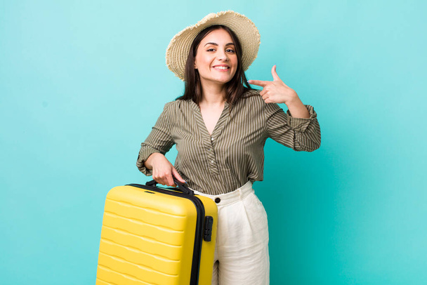 young pretty woman smiling confidently pointing to own broad smile. travel concept - Photo, Image