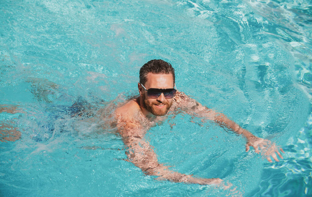 Excited man in swimming pool water. Pool spa resort. Summertime vacation. Summer man. - Φωτογραφία, εικόνα
