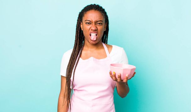 young adult black woman feeling disgusted and irritated and tongue out. empty bowl concept - Φωτογραφία, εικόνα