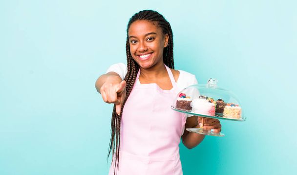 young adult black woman pointing at camera choosing you. home made cakes concept - Fotoğraf, Görsel