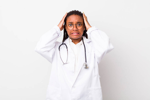 young adult black woman feeling stressed, anxious or scared, with hands on head. physician concept - Foto, Bild